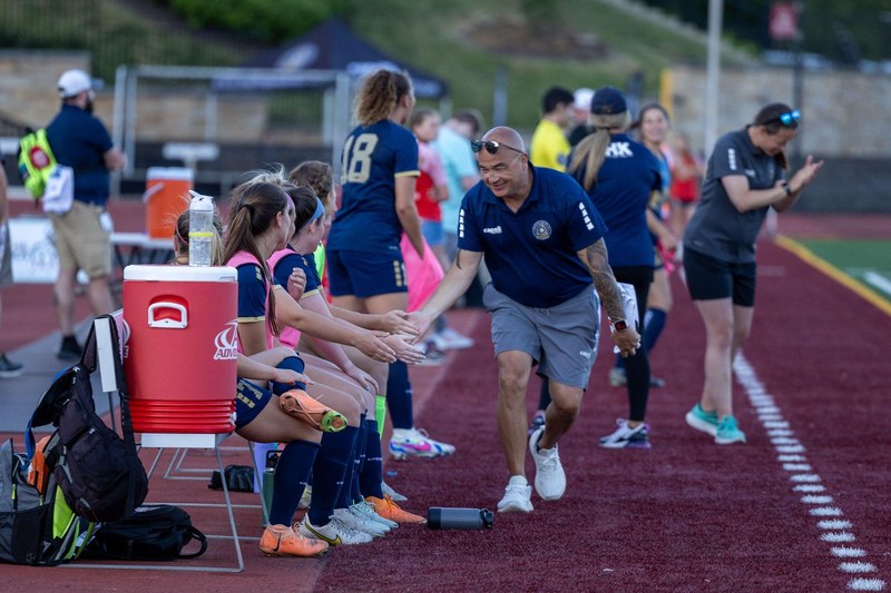 Head coach Thomas &ldquo;Goose&rdquo; Gosselin high-fives Reading United Women players on the sideline