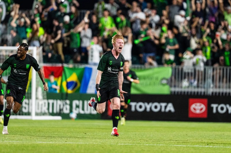 Aaron Molloy celebrates with Lexington SC teammates in front of a packed crowd