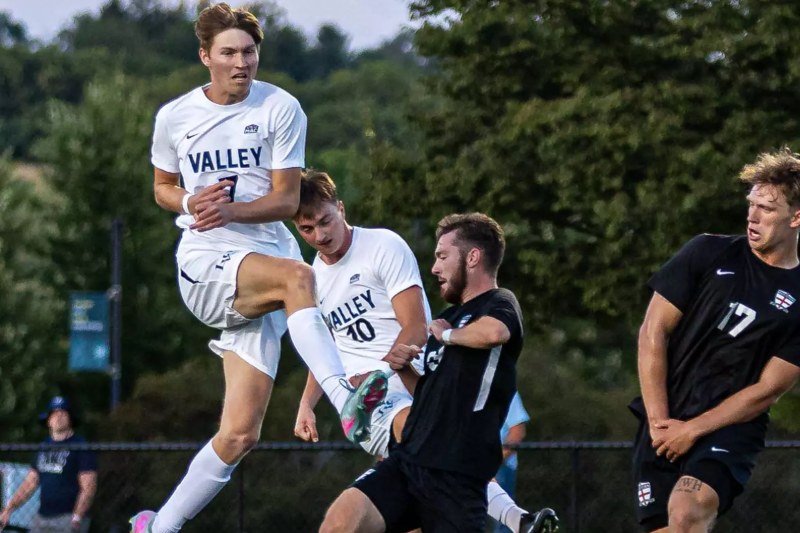 Gavin Rapp, in white No. 7, leaps for the ball for Lebanon Valley College