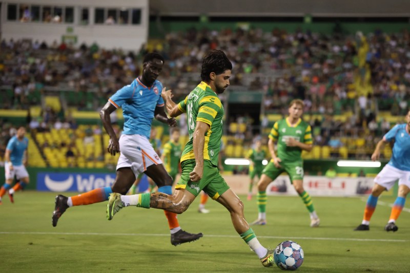 Marco Micaletto, in the Rowdies green kit, winds up to strike the ball